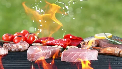 Super slow motion of falling spices on raw tuna steaks on grill grid. Stock Footage 154079563