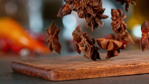 Super slow motion of falling star anise spice on wooden board. Stock Footage 166965438