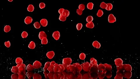 Super Slow Motion of Falling Strawberries into Water on Black Background. Stock Footage 251313773