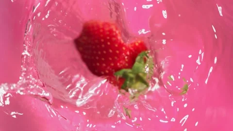 Super slow motion of falling Strawberry into splashing water. Filmed on high Video stock 199013081