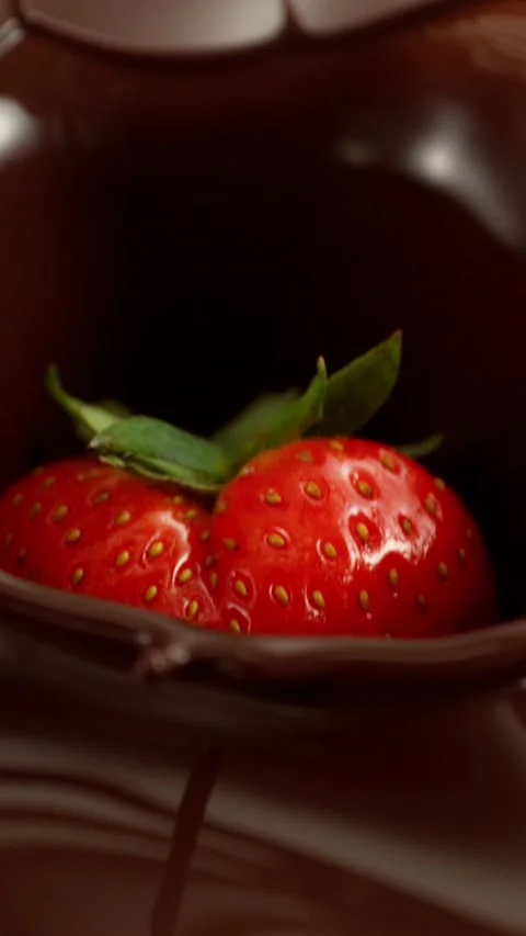 Super Slow Motion of Falling Strawberry into Melted Chocolate. Stock Footage 297449507