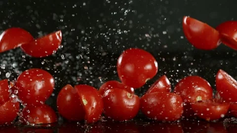 Super slow motion of falling tomatoes slices on black background. Stock Footage 237074473