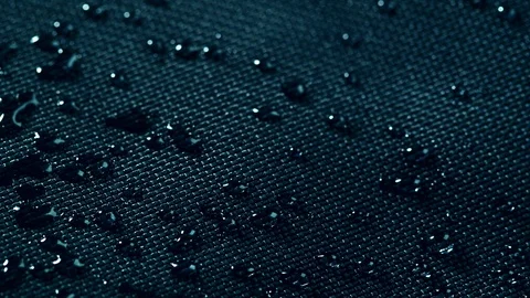 Super slow motion of falling water drops on waterproof cloth texture in detail. Stock Footage 116559262