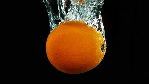 Super slow motion of falling whole orange into water. Stock Footage 212008353