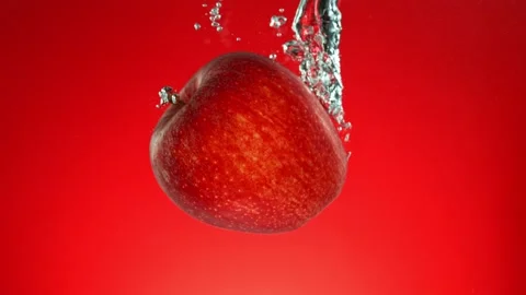 Super slow motion of falling whole red apple underwater Stock Footage 253714748