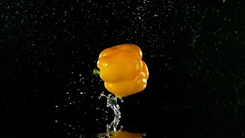 Super Slow Motion of Falling Yellow Pepper into Water on Black Background. Stock Footage 251662108