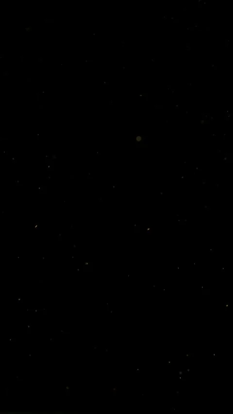 Super slow motion fine dust particles floating in the air on a black background 库存影片 335086729