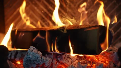 Super slow motion flames lick a log in a fireplace, glowing embers and ash Stock Footage 327892285