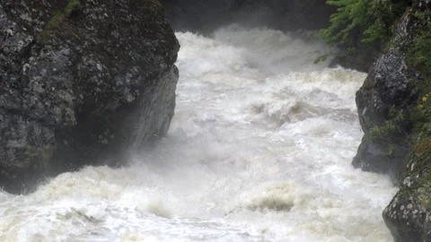 Super slow motion flood river surges through a mountain stream - River Current Stock Footage 339358204
