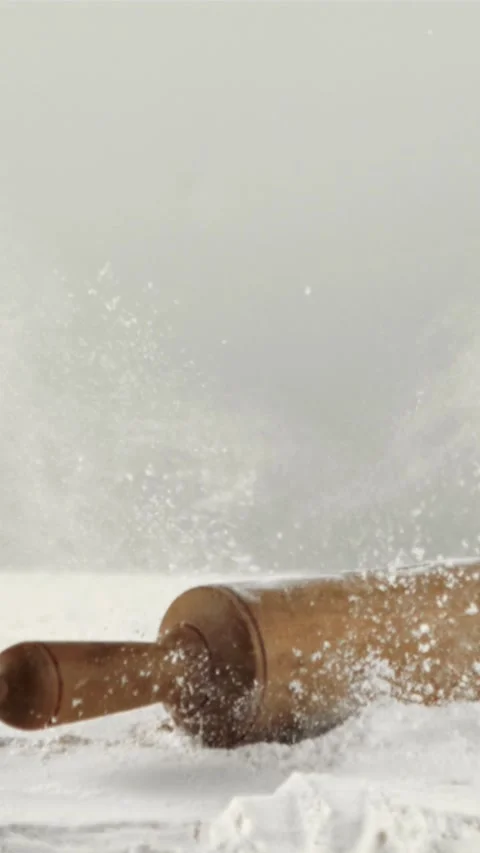 Super slow motion in the flour falls a wooden rolling pin. Filmed on a high Stock Footage 335288377