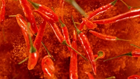 Super slow motion of flying and rotating red chilli peppers. Stock Footage 239247409