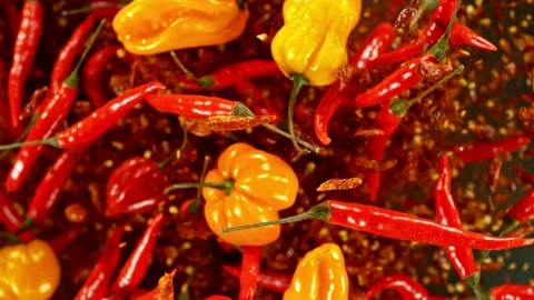 Super slow motion of flying and rotating mix chilli peppers. Stock Footage 239248884