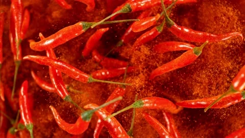 Super slow motion of flying and rotating red chilli peppers. Stock Footage 239302467