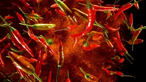 Super slow motion of flying and rotating chilli peppers. Stock Footage 282439385