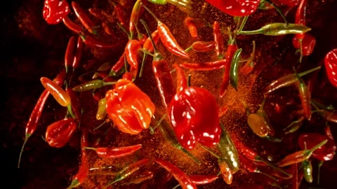 Super slow motion of flying and rotating chilli peppers. Stock Footage 282439504