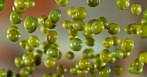 Super Slow Motion of Flying and Rotating Green Olives. Stock Footage 294185802