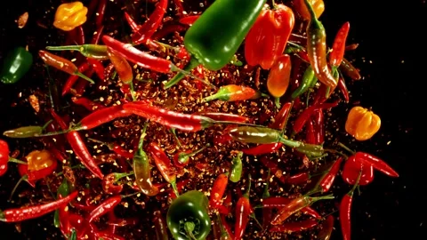 Super Slow Motion of Flying and Rotating Chilli Peppers with Dry Chilli Powder. Stock Footage 304522214