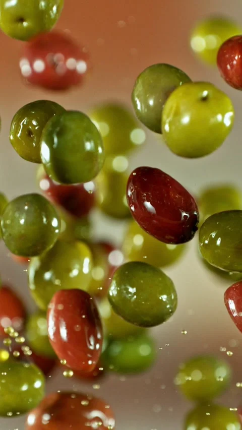 Super Slow Motion of Flying and Rotating Green and Black Olives. Stock Footage 310945501
