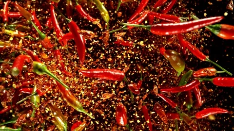 Super Slow Motion of Flying and Rotating Chilli Peppers with Dry Chilli Powder. Stock Footage 312648881
