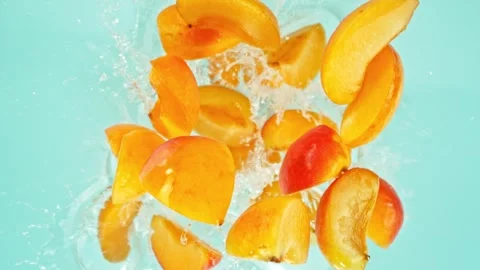 Super slow motion of flying apricot slices on blue background. Stock Footage 280253530