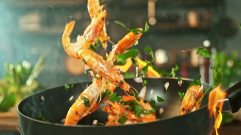 Super Slow Motion of Flying Asian Meal with Vegetable and Prawns into Wok Pan. Stock Footage 296538100
