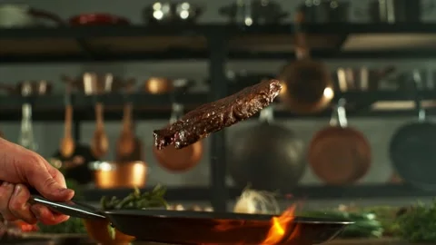 Super Slow Motion of Flying Beef Steak from Pan. Stock Footage 269944283