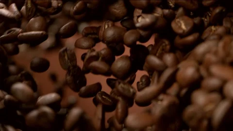 Super slow motion of flying coffee beans, rotating in tunnel Stock Footage 150156948