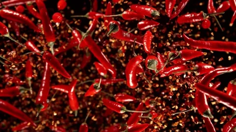 Super slow motion of flying dry and fresh red hot chilli peppers. Stock Footage 252134185