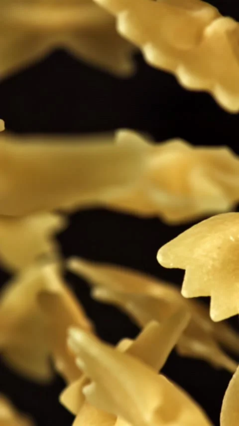 Super slow motion flying dry farfalle pasta . Filmed on a high-speed camera at Stock Footage 335375777