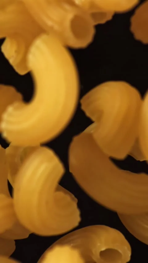 Super slow motion flying dry macaroni pasta . Filmed on a high-speed camera at Stock Footage 335375854