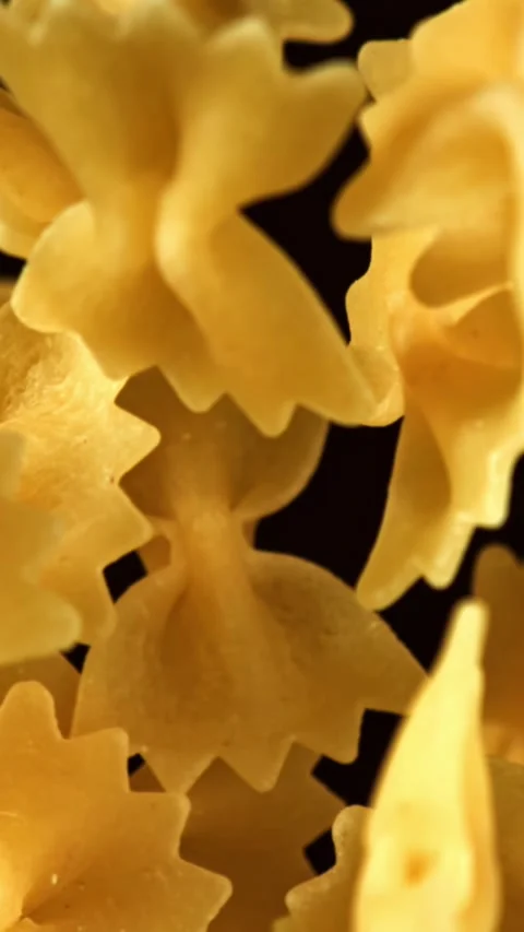 Super slow motion flying dry farfalle pasta . Filmed on a high-speed camera at Stock Footage 335377270