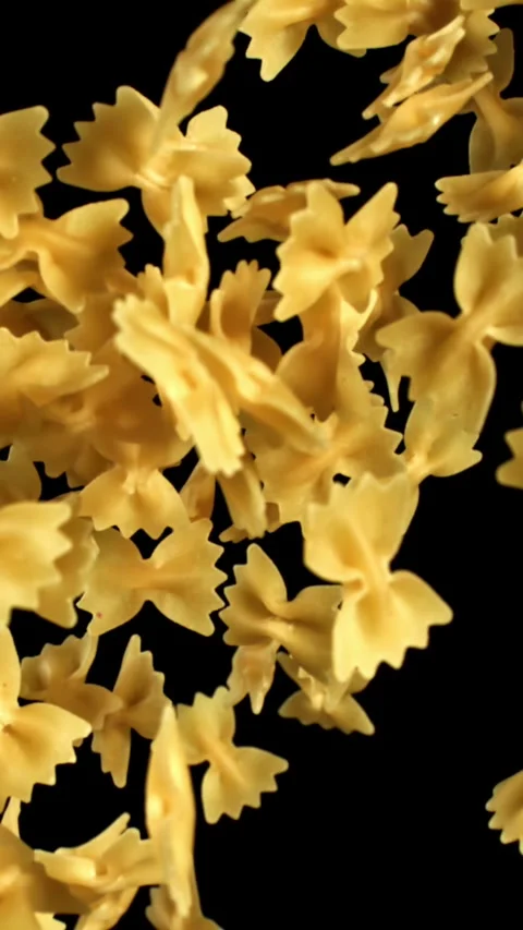 Super slow motion flying dry farfalle pasta . Filmed on a high-speed camera at Stock Footage 335377748