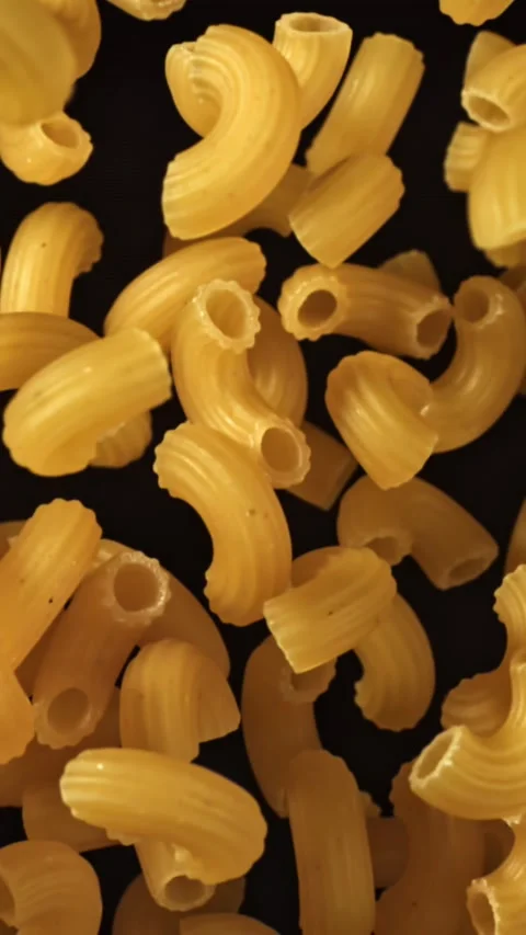 Super slow motion flying dry macaroni pasta . Filmed on a high-speed camera at Stock Footage 335378436