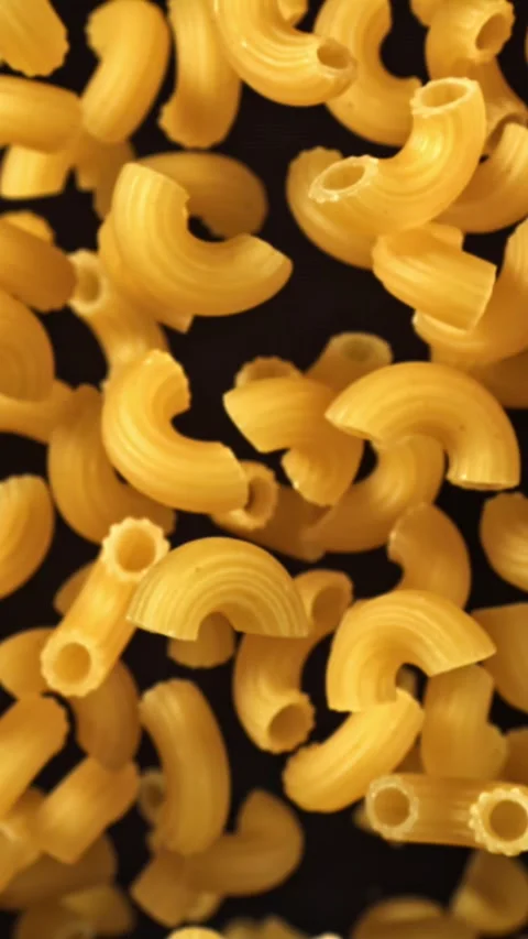 Super slow motion flying dry macaroni pasta . Filmed on a high-speed camera at Stock Footage 335380756