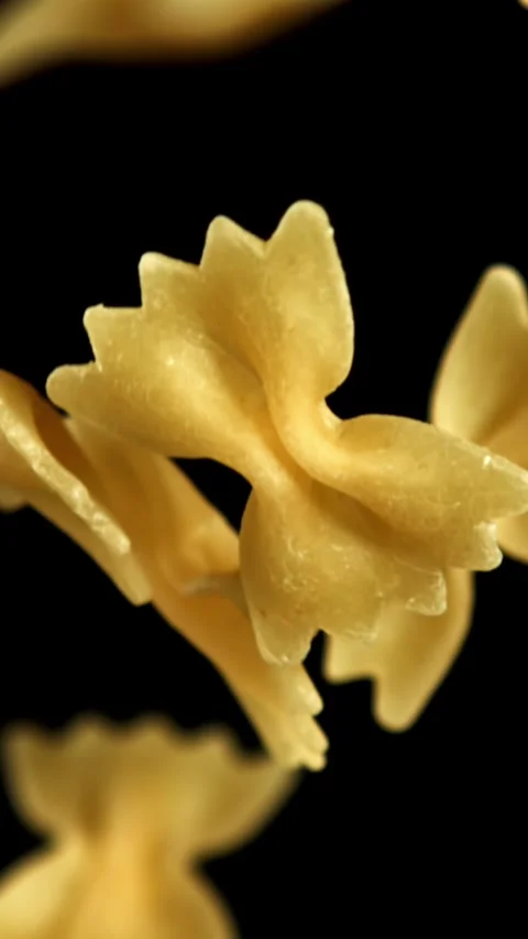 Super slow motion flying dry farfalle pasta . Filmed on a high-speed camera at Stock Footage 335382726