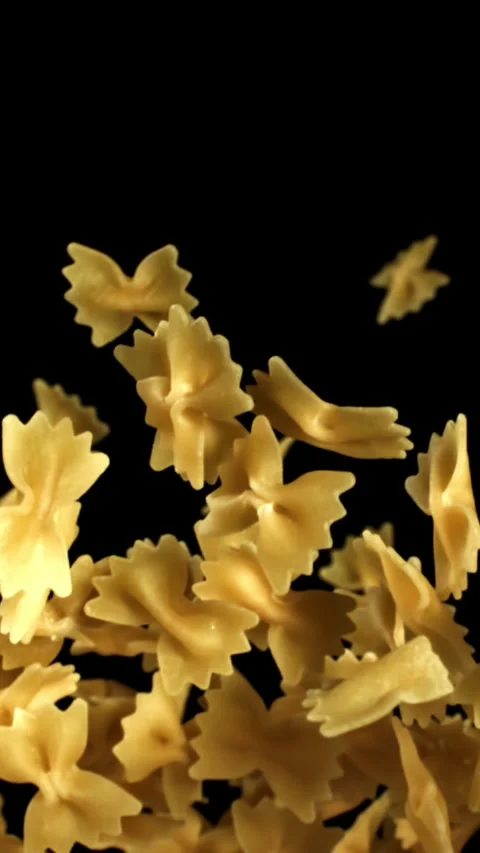 Super slow motion flying dry farfalle pasta . Filmed on a high-speed camera at Stock Footage 335383955