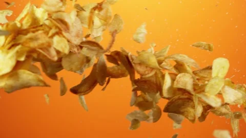 Super slow motion of flying fried potatoes chips hitting up in the air Stock Footage 139812681