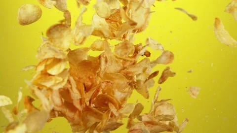 Super slow motion of flying fried potatoes chips hitting up in the air Stock Footage 139813394