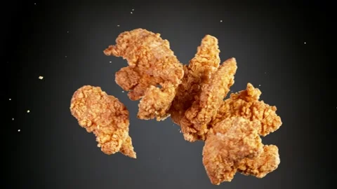 Super slow motion of flying fried chicken pieces hitting in the air. Stock Footage 161348055