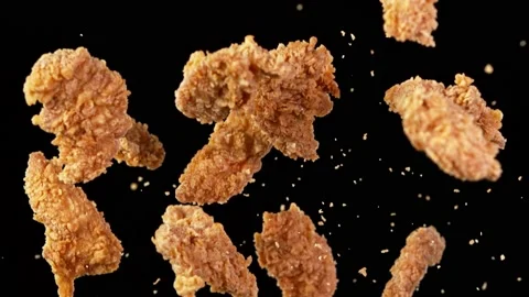 Super slow motion of flying fried chicken stripes on black background Stock Footage 161351062