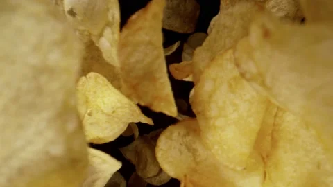 Super slow motion of flying fried potatoes chips, wide macro shot. Stock Footage 165663636