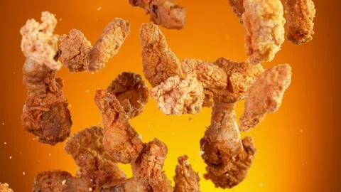 Super slow motion of flying fried chicken stripes on golden background Stock Footage 168937110
