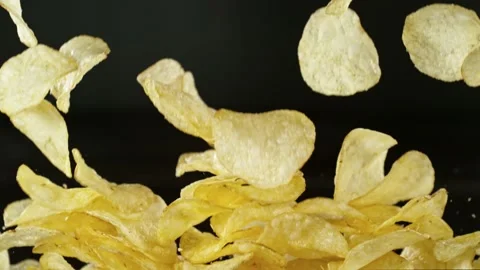 Super slow motion of flying fried potatoes chips on black background Stock Footage 237073725