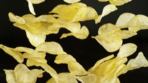 Super slow motion of flying fried potatoes chips on black background Stock Footage 237073871