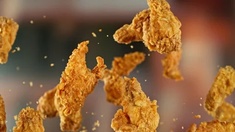 Super Slow Motion of Flying Fried Chicken Wings and Pieces. Stock Footage 306651258
