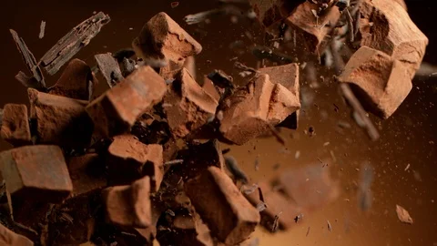 Super slow motion of flying group of raw chocolate pieces. 119442730