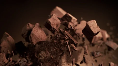 Super slow motion of flying group of raw chocolate pieces. Stock Footage 119483453