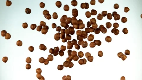 Super slow motion of flying hazelnuts collision Stock Footage 132255622