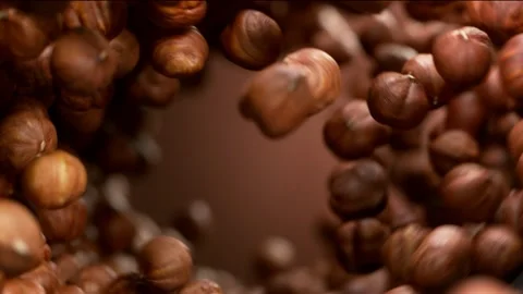 Super slow motion of flying hazelnuts in rotating movement Stock Footage 150163537