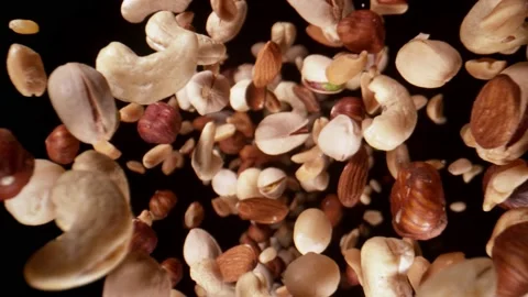Super slow motion of flying nuts mix in wide macro shot. Stock Footage 165663952